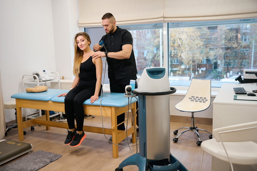 Woman at a shock wave therapy session
